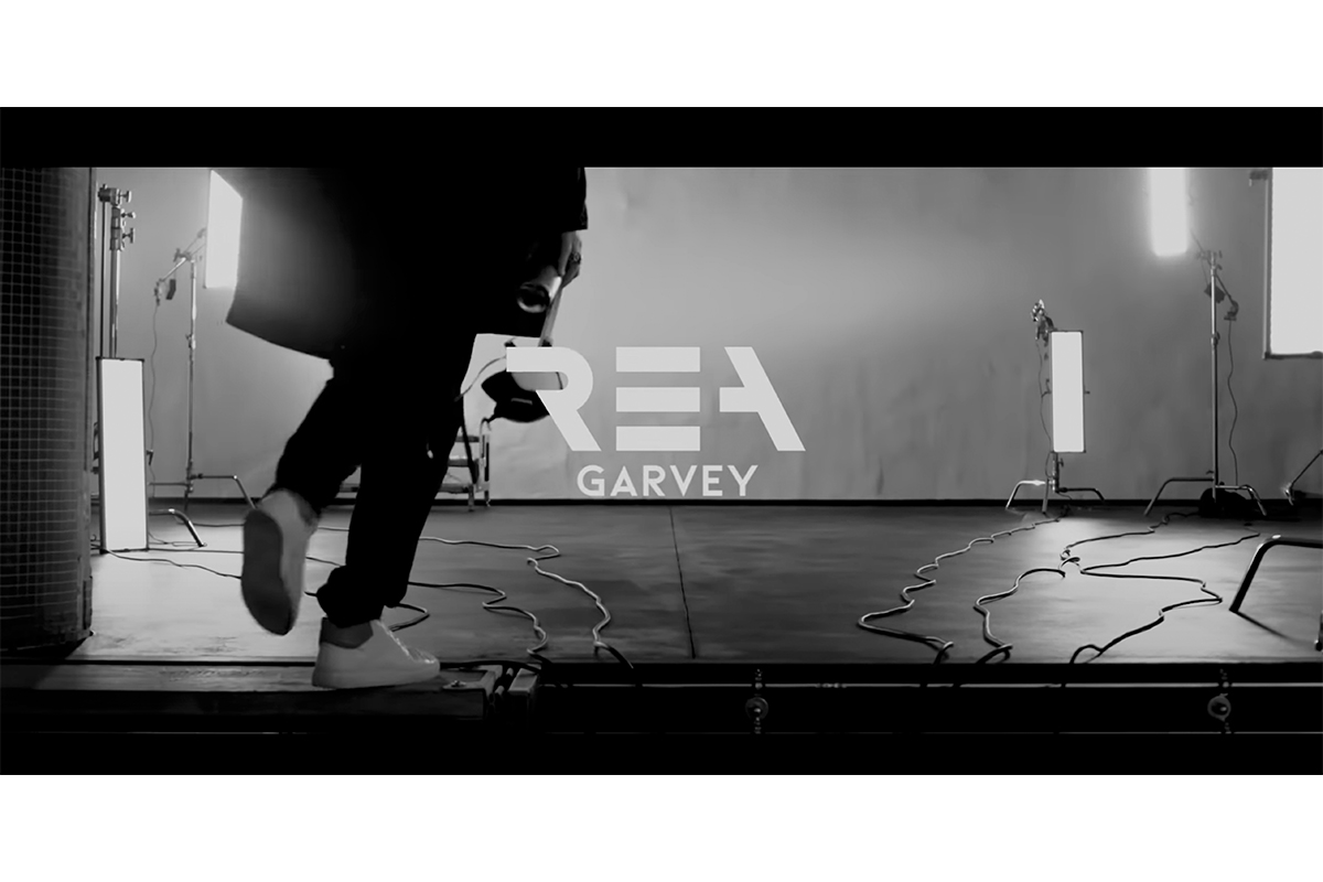 "Rea Garvey stepping into a stark, monochrome studio, a scene from his music video 'Is It Love?' featuring Kool Savas"