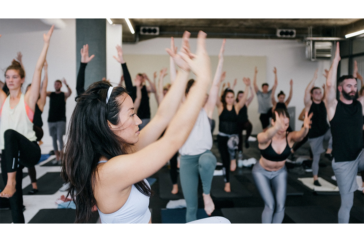 A group of yoga enthusiasts practicing yoga in a spacious studio at RAW Studios, Berlin