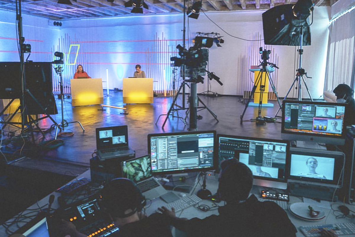 Wide shot of three Junge Liberale members seated on stage during their digital streaming event (Buko62).