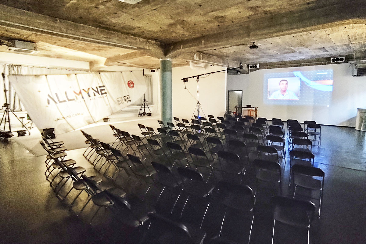 A well-arranged seating setup in a dimly lit industrial-style venue at raw studios., prepared for the Ocean Race talk event.