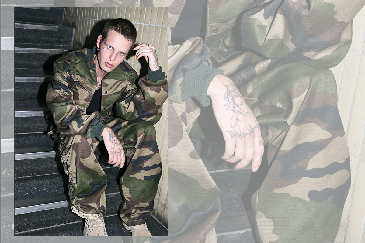 Model in camouflage jumpsuit from nowrubi capsule collection photographed at raw studios by Bert Spangemacher – contemporary fashion shoot in Berlin Foto Studio.