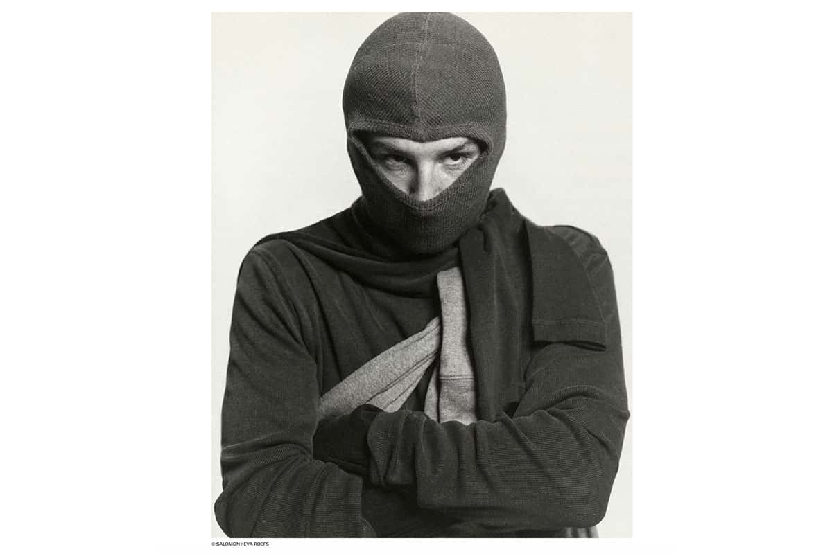 Black-and-white portrait from the Salomon x Highsnobiety shoot at raw studios., a rental studio in Berlin, showing a male athlete in a knit balaclava and layered performance clothing.
